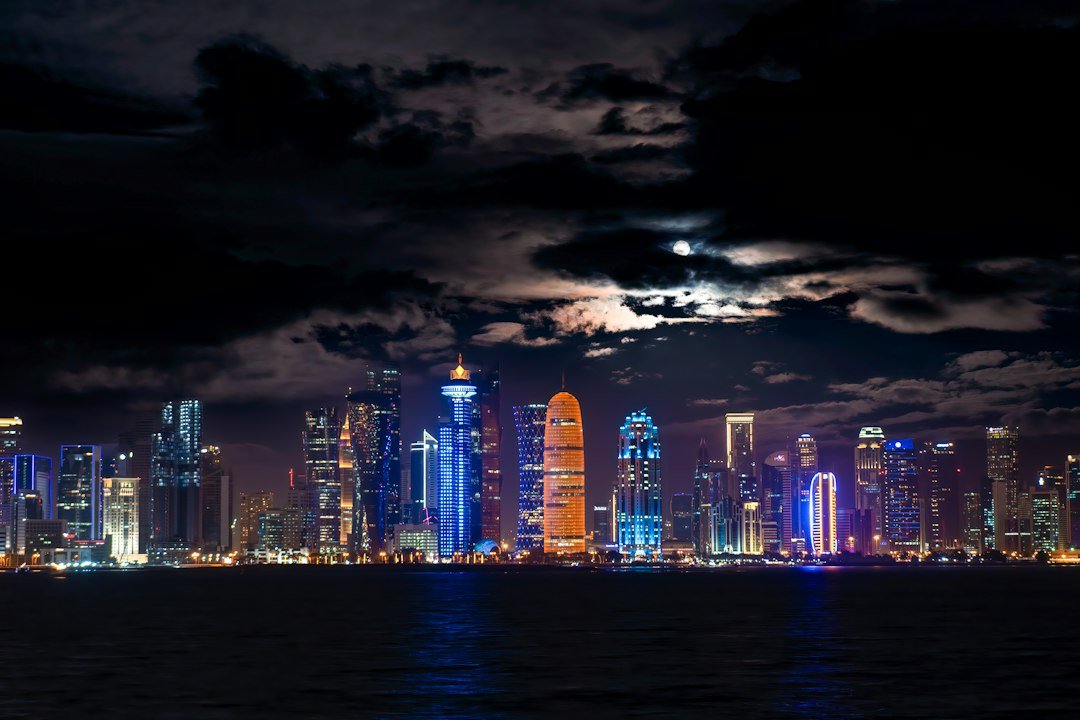 Doha skyline at night, showing the Qatar setting for this utility move-out guide